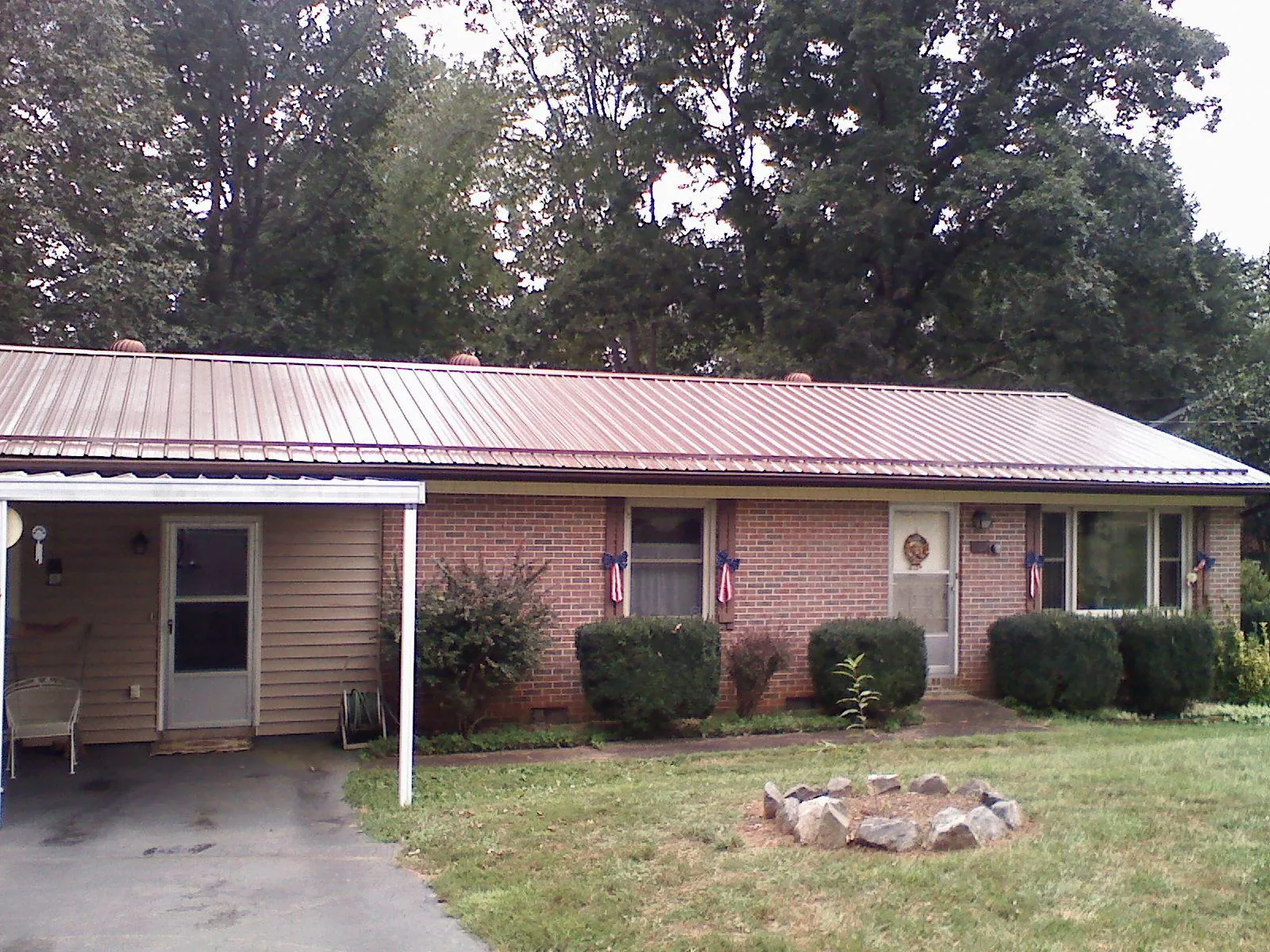 Bronze metal roof and carport on a brick ranch home — Roof Repair work by our crew in Grovetown