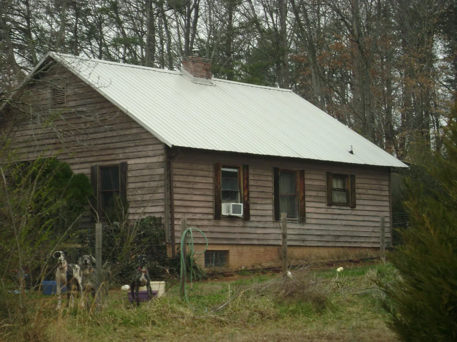 White metal roof on an old wood sided farmhouse, from a Metal Roof Installation job in Grovetown